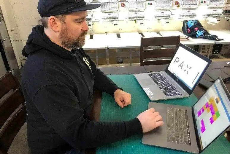 man working behind laptop